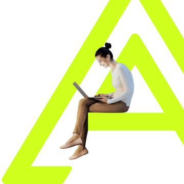 a person sitting on a chair using a laptop